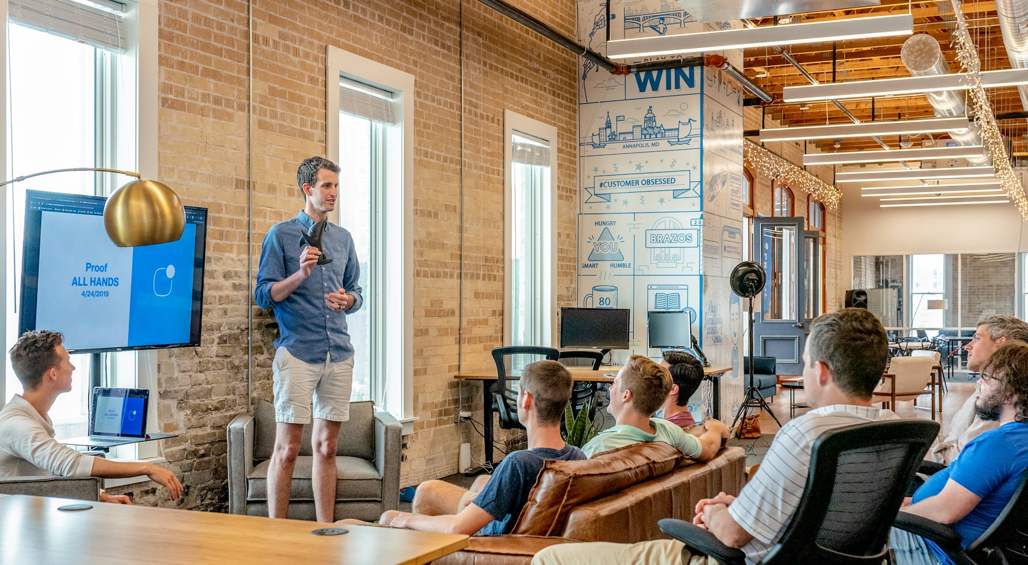 Students presenting a venture idea to classmates in a studio space